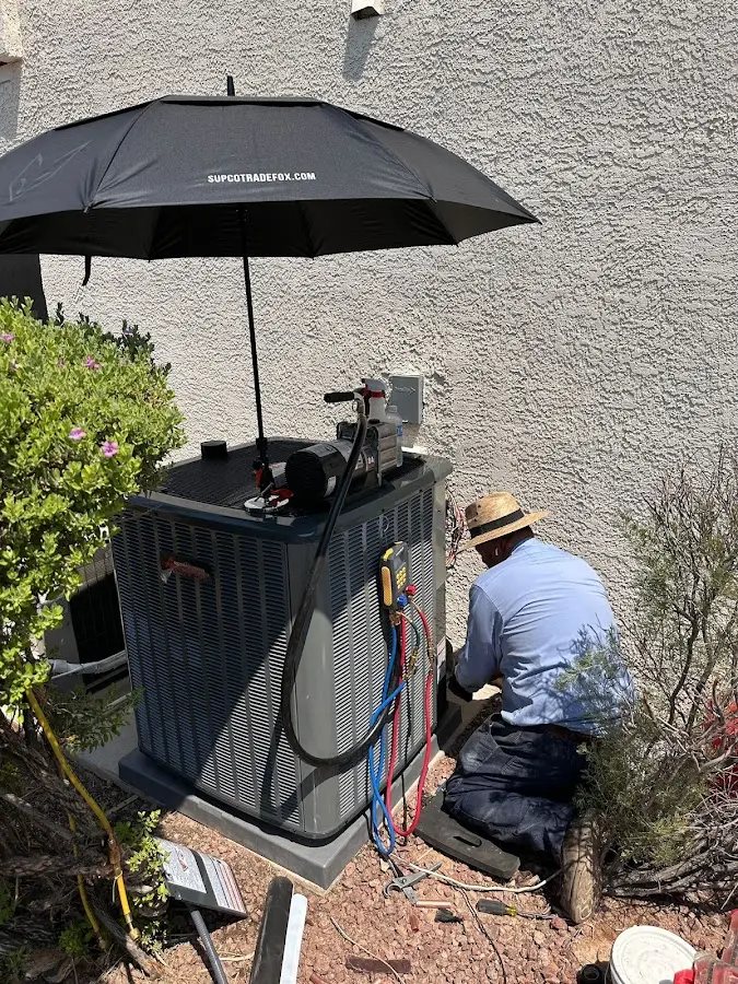 HVAC technician performing outdoor AC maintenance in Cleveland